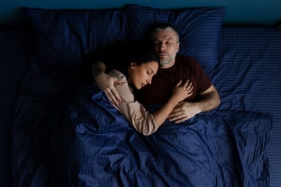 Couple sleeping peacefully on a bed