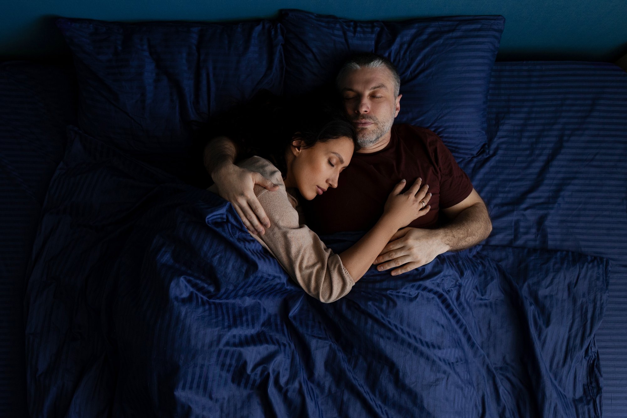 Couple sleeping peacefully on a bed