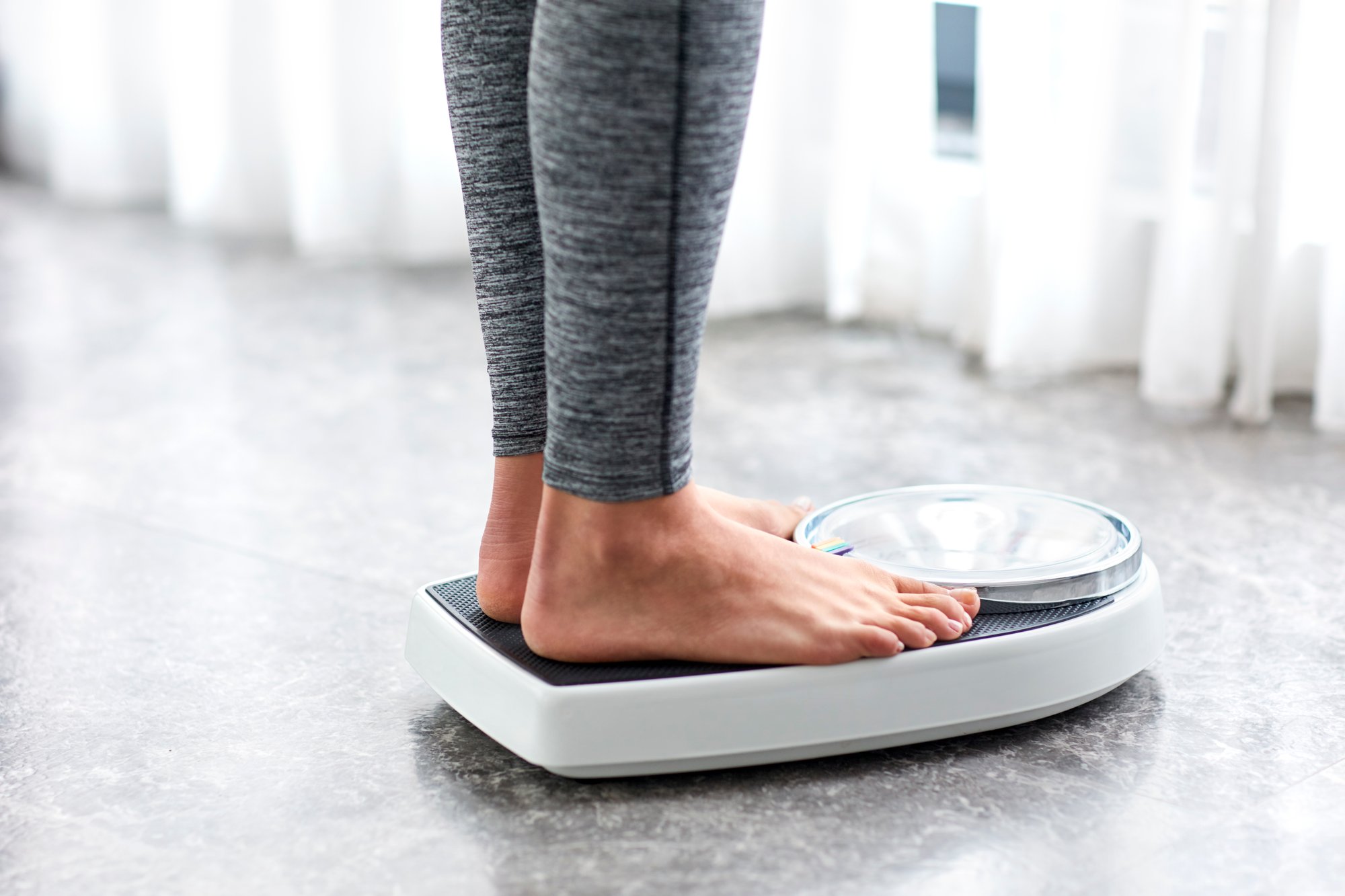 Person standing on a weighing scale.