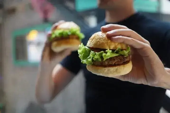 man-with-burger-in-hand